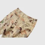 Hellstar Studios Bermuda War Shorts in desert camo print with custom patches and graphic details on sand fabric.