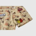 Hellstar Studios Bermuda War cargo shorts in desert camo with signature patches and flaming smiley graphics.
