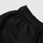 Close up view of the premium heavyweight black cotton fleece fabric and elastic waistband of Hellstar Studios shorts.