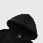 Close-up view of the black Hellstar Studios hoodie showcasing the hood design and inner brand label detail.