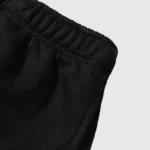 Close-up view of the premium black cotton fleece material and gathered elastic waistband on Hellstar Studios shorts.
