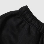 Close-up view of the black elastic waistband on premium heavyweight cotton fleece Hellstar Studios streetwear shorts.