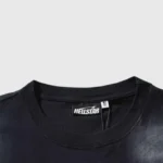 Close-up view of the interior neck label on a black Hellstar Studios Cartoon Logo cotton crew neck T-shirt.