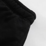 Close-up view of the black elastic waistband on a pair of Hellstar Studios Classic black shorts against white background.