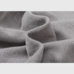 Close-up detail of the premium soft grey cotton fabric used in the Hellstar Studios Flame Grey unisex tracksuit.
