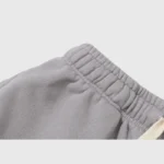 Close up of the grey cotton fabric and elastic waistband of a Hellstar Studios Flame Grey unisex tracksuit.
