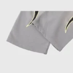 Close-up view of the premium grey cotton fabric and flame graphic detail from the Hellstar Studios Flame Grey Tracksuit.