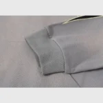 Close up of the ribbed sleeve cuff on the grey Hellstar Studios Flame Grey unisex cotton tracksuit with vintage wash.