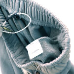 Detail view of the 100% cotton interior tag inside the Hellstar Studios Flame Grey vintage washed sweatpants.