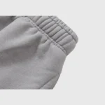 Close-up view of the elastic waistband on the grey Hellstar Studios Flame sweatpants featuring high-quality fabric.