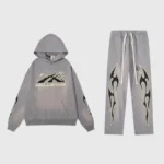 Grey Hellstar Studios matching hoodie and sweatpants set featuring a black flame graphic design on a faded background