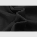 A close-up look at the premium black fleece fabric used in the Hellstar Studios Heaven On Earth streetwear hoodie.