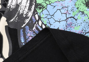 Close-up view of the graphic print detail on a black Hellstar Studios Heaven on Earth cotton T-shirt fabric texture.