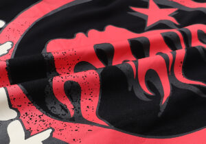 Detailed close-up view of the Hellstar Studios Heaven on Earth black t-shirt with red graphic print design.