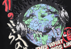 Close-up view of the Heaven on Earth graphic featuring a cracked earth and headphones on a black Hellstar Studios T-shirt.