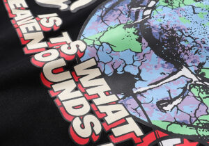 Close-up of the Hellstar Studios Heaven on Earth T-shirt graphic print featuring colorful globe and text details.