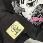 Close-up view of the Hellstar Studios Heaven Sounds Like T-shirt featuring the authentic yellow brand tag and graphic.