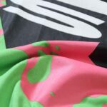 Close-up fabric texture detail of the Hellstar Studios Jesus Emblem lime green graphic T-shirt featuring custom print.