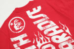 Close-up view of the back of a red Hellstar Studios Jesus Emblem graphic T-shirt featuring stylized flame typography