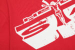 Close-up of the white Jesus emblem graphic printed on a vibrant red Hellstar Studios fashion t-shirt design.