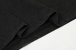 A detailed close-up shot of the soft black cotton fabric texture used for the Hellstar Studios Jesus Emblem T-Shirt.