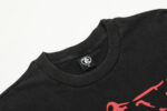 Close up view of the black Hellstar Studios Jesus Emblem T-Shirt showing the branded neck tag detail with size label