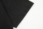 A detailed close-up view of the black sleeve stitching on the Hellstar Studios Jesus Emblem T-Shirt design.