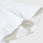 Close-up view of the sleeve hem on the white Hellstar Studios Jesus Emblem T-Shirt showing premium cotton fabric.