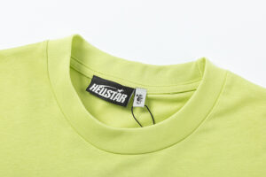 Close-up of the neck detail on a vibrant lime green Hellstar Studios short sleeve t-shirt with branded clothing tag.