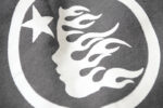 White Hellstar Studios logo featuring a flaming face and star detail on Jet Black Racer Flare sweatpants fabric