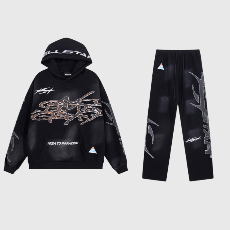 Hellstar Studios Path To Paradise black tracksuit featuring a graphic hoodie and matching drawstring pants set.