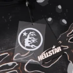 Detailed close-up of the official Hellstar Studios Path To Paradise clothing brand tag on black graphic streetwear.