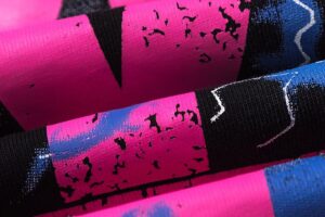 Close-up view of the vibrant pink and blue electric graphic screen print design on the Hellstar Studios cotton t-shirt.
