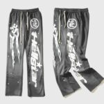 Hellstar Studios Racer Flare Sweatpants in Jet Black featuring high-density screen-printed graphic logo and star designs.