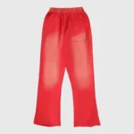 Back view of bright red Hellstar Studios Racer Flare sweatpants with a vintage-washed finish and pocket detail.