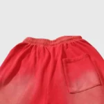 Back view of red Hellstar Studios Racer Flare sweatpants featuring an elastic waistband and a single pocket.