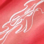 Close up of the white flame graphic detail on red Hellstar Studios Racer Flare sweatpants fabric.
