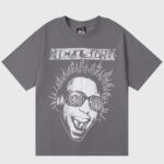 Hellstar Studios Rage T‑shirt dark grey with distressed electrified face graphic wearing headphones and Hellstar logo