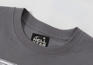 Close-up view of the dark grey collar and Hellstar Studios brand logo label on the Rage unisex cotton T-shirt.