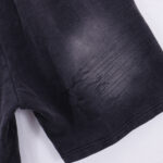Close-up detail of the black Hellstar Studios Records shorts featuring a textured graphic print and distressed fabric finish.