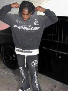 Model wearing a black Hellstar Studios Records vintage tracksuit with graphic prints and drawstring hoodie details.