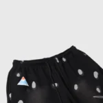 Detailed view of the Hellstar Studios Records black tracksuit pants featuring a patterned graphic and logo detail.