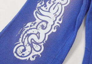 Detail of the blue Hellstar Studios Records yoga sweatpants featuring a distressed white graphic screen print design.