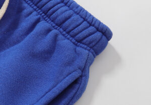 Close-up view of the elastic waistband and premium blue fleece fabric on Hellstar Studios Records yoga sweatpants.