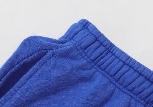 Close-up view of the elastic waistband on the blue Hellstar Studios Records yoga sweatpants for men and women.
