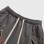 Close-up view of the elastic waistband and drawstring detail on vintage-washed brown Hellstar Studios Records shorts.