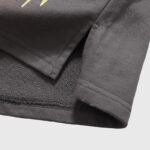 Close-up view of the reinforced hem detail and fleece fabric on the brown Hellstar Studios Records streetwear shorts.