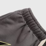 Close-up view of the ribbed waistband on a pair of brown Hellstar Studios Records shorts for a premium street style fit.