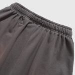 Close-up view of the elastic waistband on the brown Hellstar Studios Records vintage wash streetwear shorts.