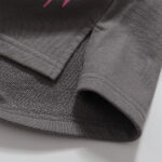 Close-up view of the grey Hellstar Studios Records shorts, focusing on the stitched hem and side slit fabric detail.